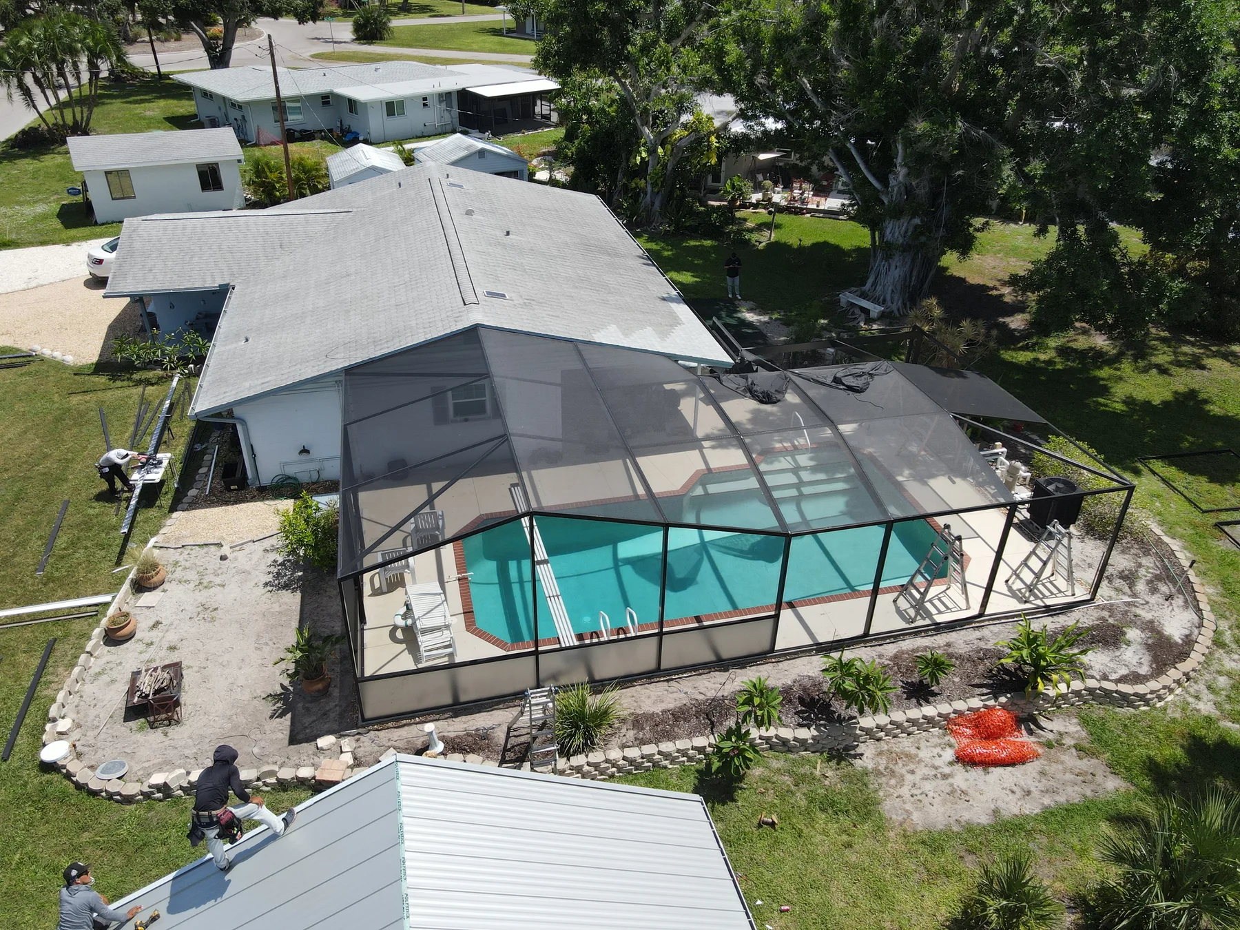 Aerial view of a pool enclosure installation in progress