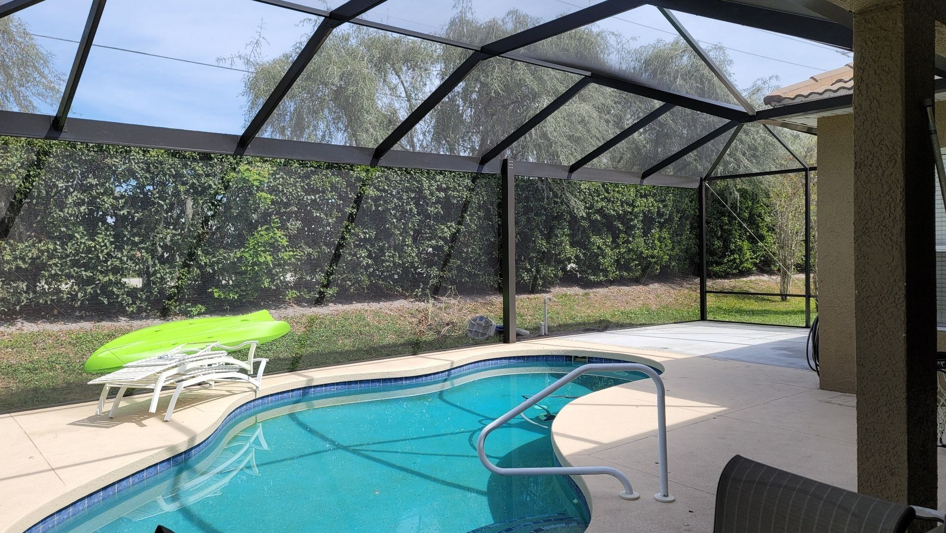 Rescreened pool enclosure with renewed dark mesh and aluminum framing